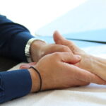 Hand therapist massaging a patient's hand.
